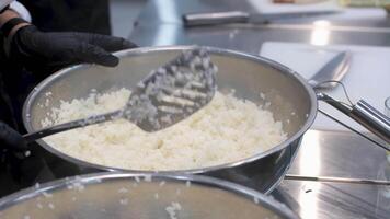 sushi tempura Cook's hands close-up. A chef makes sushi and rolls from rice, red fish, avocado and philadelphia cheese. step by step. make sushi video