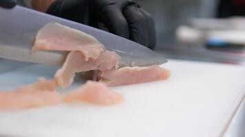 cut the chicken fillet Close up woman's hands cutting chicken fillet.Food preparation. Chicken meat on the table. Cooking food. video