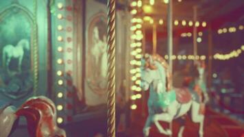 Empty amusement park at night featuring illuminated carousel with horses video