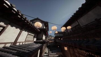 Traditional Japanese street adorned with lanterns under a clear blue sky video