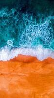 An aerial view of the ocean and sand photo