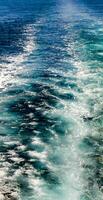 A boat is sailing in the ocean with a sail photo