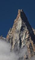 A mountain with a large rock on top photo