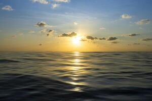 Sunset sky at the lake with motion wave and clouds photo
