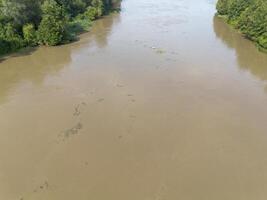 Mudflow of water in the Oder River of brown color. Poland. View from above. Background. photo