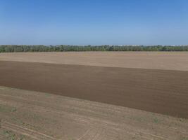 Plowed agricultural field, view from above, background. photo