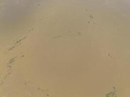 Mudflow of water in the Oder River of brown color. Poland. View from above. Background. photo