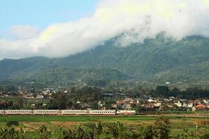 The train passes through the countryside with beautiful natural views. photo