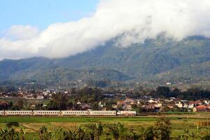 The train passes through the countryside with beautiful natural views. photo