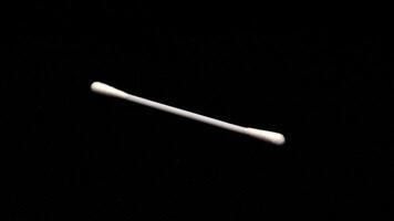 Cotton swabs isolated on black background photo