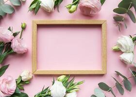 Elegant floral frame setup with pink background featuring fresh roses and greenery for decoration or display photo