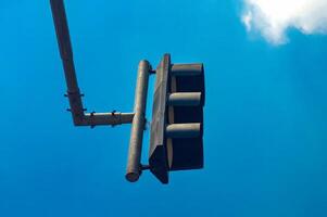 Urban traffic light close up against blue sky with clouds, symbolizing regulation and control photo