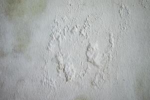 Close up of aged white wall texture with peeling paint and visible wear perfect for background or design element photo