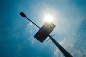 Solar panel on a pole with a street lamp, capturing sunlight against a clear blue sky. Perfect for urban renewable energy concepts photo
