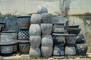 Stacked decorative concrete planters with ethnic patterns in an outdoor setting, showcasing artisanal garden decor photo