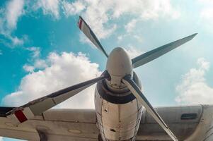 Close up of an airplane propeller against a blue sky with clouds, showcasing detailed aviation engineering and design, Surabaya, 22 September 2024. photo