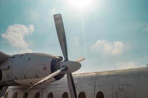 Close up of an airplane propeller against a blue sky with clouds, showcasing detailed aviation engineering and design, Surabaya, 22 September 2024. photo