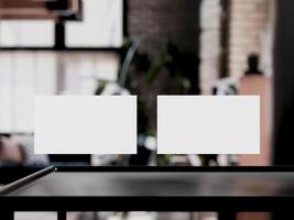 Clean minimal business card mockup on table with office background photo