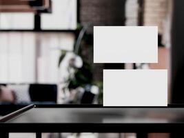 Clean minimal business card mockup on table with office background photo
