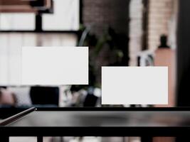 Clean minimal business card mockup on table with office background photo