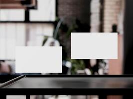 Clean minimal business card mockup on table with office background photo