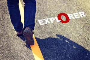 A person walking on a road with the word explorer written on it photo