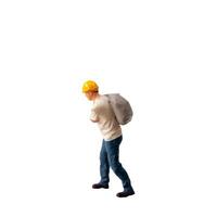 Miniature construction worker carrying a heavy sack on his back isolate on white background with clipping path photo