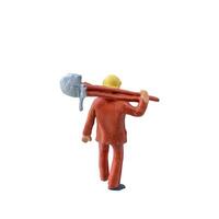 Miniature worker with a shovel slung over his shoulder. isolate on white background with clipping path photo