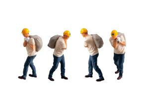 Miniature construction worker carrying a heavy sack on his back isolate on white background with clipping path photo