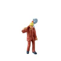 Miniature worker with a shovel slung over his shoulder. isolate on white background with clipping path photo