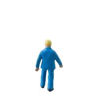Miniature construction worker dressed in a blue jumpsuit isolate on white background with clipping path photo
