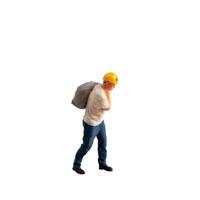 Miniature construction worker carrying a heavy sack on his back isolate on white background with clipping path photo