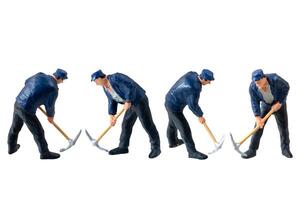 Miniature worker, wearing a blue jacket and cap, isolate on white background with clipping path photo
