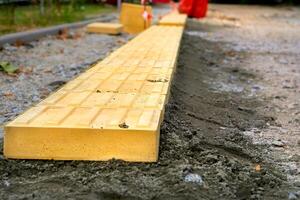 Road works. Laying pedestrian tiles with relief for the blind photo