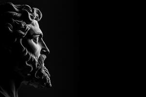 A monochrome photograph of a classical sculptures face with detailed texture, side lit for dramatic effect. Dark back photo