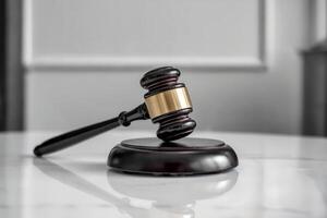 Wooden gavel on a sound block in a courtroom setting. photo