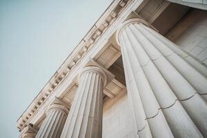 Close-up view of classical Greek columns under a clear sky. photo