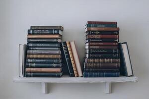 A bookshelf filled with various classic and modern books. photo