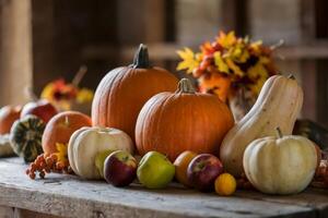 Array of pumpkins, gourds, and apples on a rustic wooden table. photo