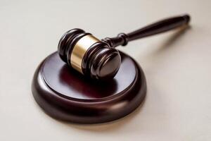 Close-up of a wooden gavel and sound block on a light surface. photo