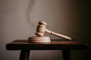 Wooden gavel and block on a wooden table, symbolizing justice and law. photo