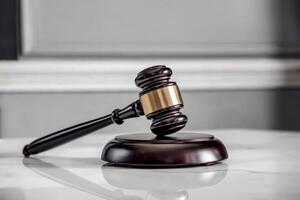 Close-up of a judge's gavel on a polished desk. photo
