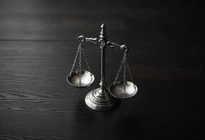 Silver balance scale on dark wooden table, symbolizing justice and equality. photo