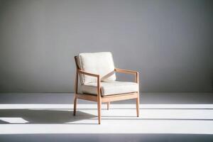 Elegant wooden armchair with cream cushions in minimalist setting. photo