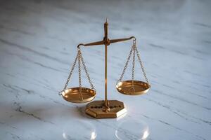 Golden balance scale on a marble surface, symbolizing justice and equality. photo