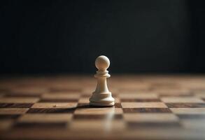 Lone white pawn on a wooden chessboard under focused lighting. photo