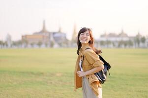 A Traveler Asian woman in her 30s exploring Wat Pra Kaew. From stunning architecture to friendly locals, she cherishes every moment, capturing it all in her heart and camera for years to come. photo