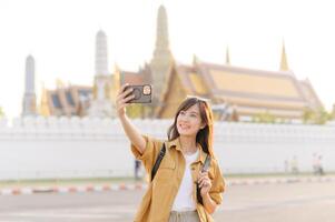Traveler asian woman in her 30s explores the Grand Palace with a local guide. Uncover hidden gems and immerse yourself in Thai culture with her adventure. photo