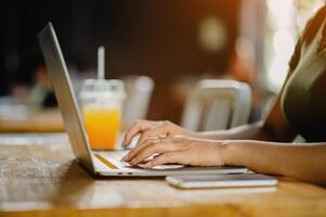 Typing on a laptop, working in a coffee shop, freelancing and independent work photo