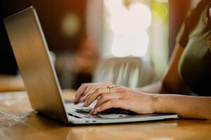 Typing on a laptop, working in a coffee shop, freelancing and independent work photo